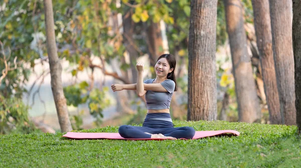 stock image Asian woman doing yoga in nature in the forest, Meditation and breathing exercises, Treat ADHD and train your mind to be calm, Healthy exercise, Mindfulness, Homeopathy, Park yoga.