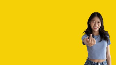 Women beckoning or inviting them to pay attention, Suggest to click or apply with me, Giving assistance and acceptance, Calling with one finger, Come and get me, Woman on yellow background.