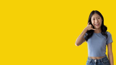 Call sign, Bright young asian woman inviting to call isolated on yellow background, Suggest to call or invite to apply for membership, Isolated on yellow background