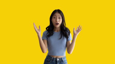 Asian woman acting shocked or surprised isolated on a white background,  Looking camera, Concept acts according to the emotions and feelings of excitement and shock, Yellow background, Copy space.