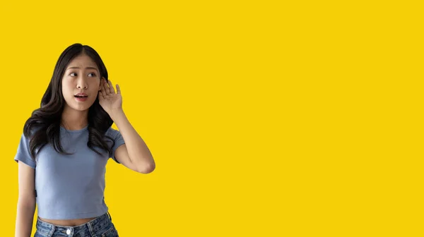 Asian Woman Eavesdropping Overhearing Secret Conversation Isolated Yellow Background Gossip — Stock Photo, Image