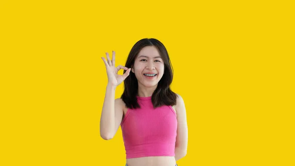 Young Asian Woman Yellow Background Doing Sign Hands Symbol Welcome —  Fotos de Stock