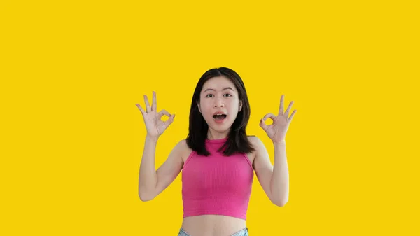 Young Asian Woman Yellow Background Doing Sign Hands Symbol Welcome — Stok fotoğraf