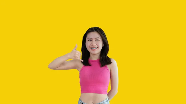 Call Sign Bright Young Asian Woman Inviting Call Isolated Yellow —  Fotos de Stock