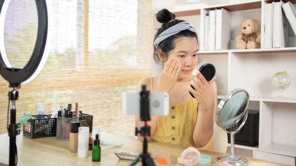 Beautiful women with social media influences are teaching makeup and use cosmetics, In front of the camera to recording vlog video live streaming, Online business on concept of beauty bloggers.