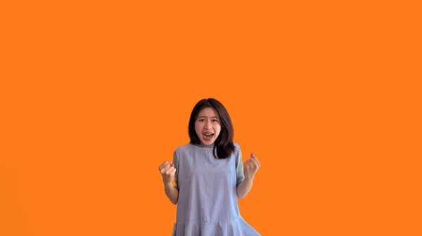 勝つために非常に幸せをポーズアジアの女性 極端な幸福を表示 非常に幸せ オレンジの背景にロンリー女性 — ストック写真