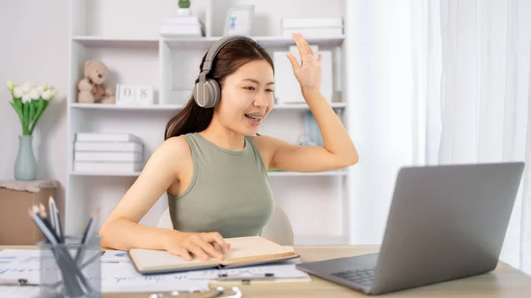 stock image Asian female student chatting or exchanging knowledge through laptop video call, Education through wireless education system, Conversations with teachers and classmates, Online learning, Study at your own home.