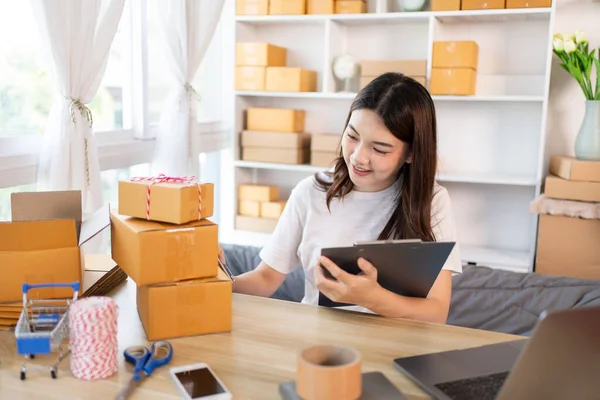 Online selling business, Small business owners are checking inventory in order to prepare them for proper delivery to customers,  Working from Home: Managing E-commerce Operations.