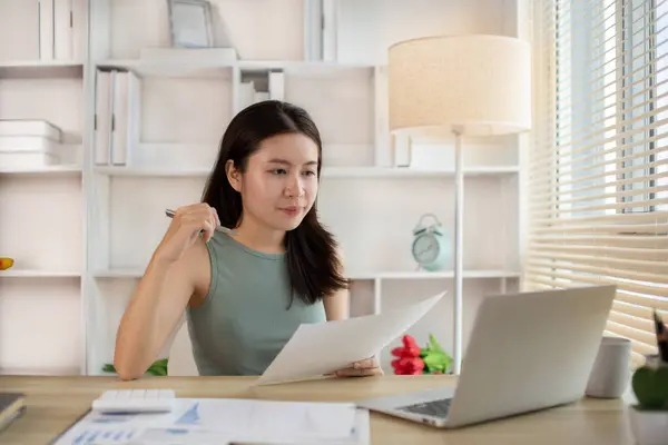 Young woman Working from Home, Video Call with Customer in Office, Remote Business Communication, Telecommuting Professional, Virtual Video Call with Office Customer, Work from Home Concept.