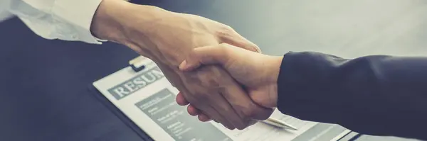 Close-up of Head of Human Resources and new employees Shake hands to congratulate them on their collaboration, Successful job interviews and the willingness to work together concept.