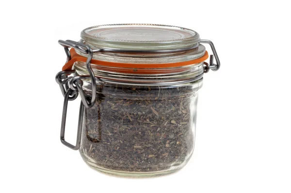 stock image Jar of dried basil close up on white background 