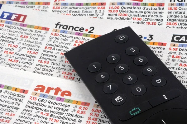 Stock image TV program with a remote placed on it 