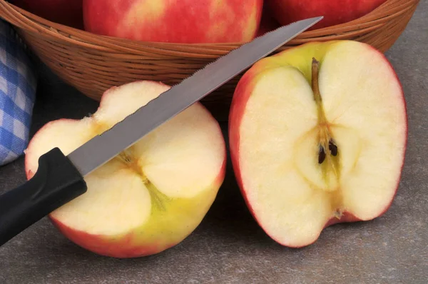 Apple cut in half with a knife close-up