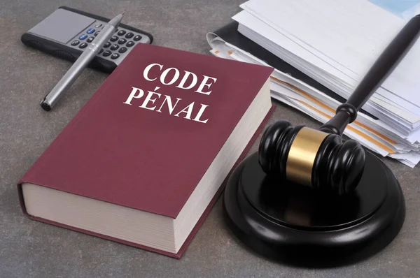 French penal code book with a judge gavel