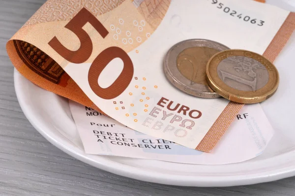 stock image French cash receipt in a saucer with a fifty euro note and change