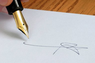 Signature with a fountain pen close-up on a white sheet