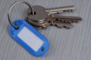 Bunch of keys with a keychain on a wooden background