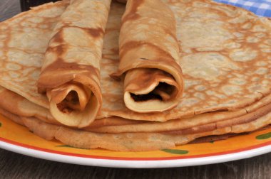 Krep üzerine yakın plan bir tabakta duran yuvarlak krepler.