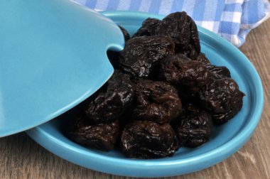 Prunes in a tagine dish close up