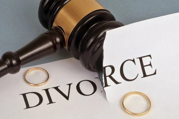 Divorce concept with wedding rings and judge gavel