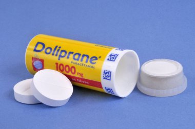 Tube of Doliprane 1000 effervescent breakable tablets opened close up on blue background