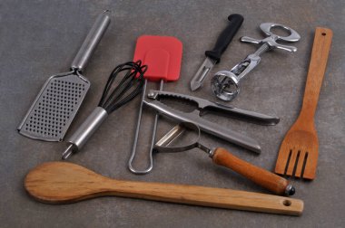 Assortment of kitchen utensils close up on gray background