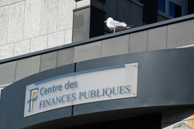 Entrance to the public finance center of Vannes in Brittany with a seagull above