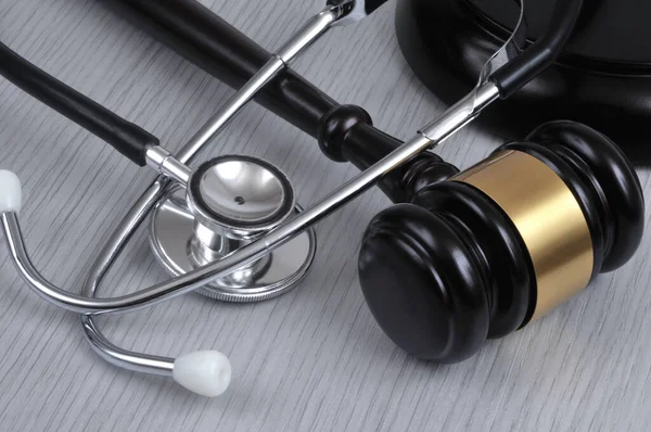 Medical error concept with a stethoscope and a judge gavel close-up