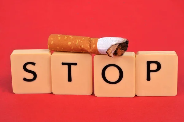 Quit Smoking Concept Alphabet Letters Cigarette Butt Red Background — стокове фото