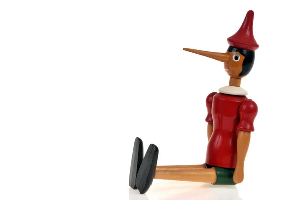 Wooden Pinocchio Puppet Sitting White Background — Stock Photo, Image