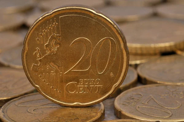 Close-up twenty cent euro coin lying on a background of coins
