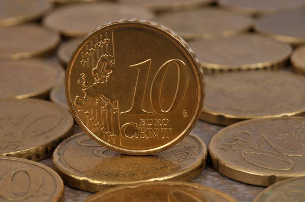 Close-up ten cent euro coin lying on a background of coins