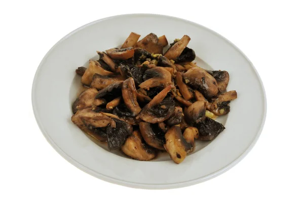 stock image Plate of cooked mushrooms with garlic close-up on a white background