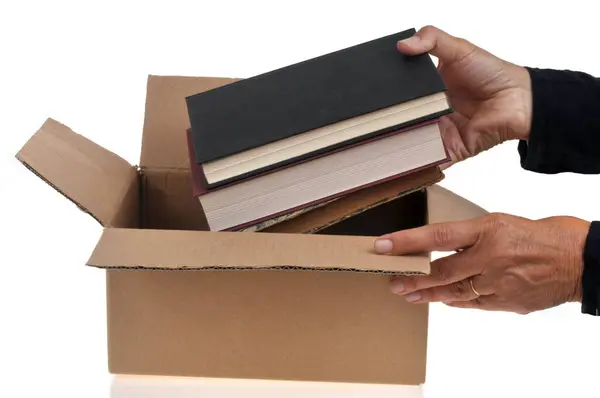 Birisi Kitapları Beyaz Arkaplana Yakın Bir Kutuya Koyuyor — Stok fotoğraf