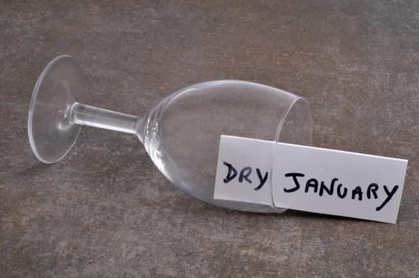 Dry January Concept Empty Overturned Glass Gray Background Text Card — Stock Photo, Image