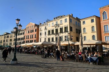 Terraces of bars and restaurants on the Riva degli Schiavoni in Venice clipart