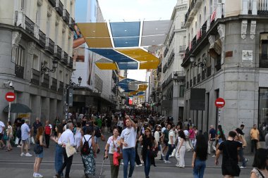 Madrid 'de kalabalık, güneşten korunan Calle de Preciados renkli tuvallerle caddenin karşısına uzandı.