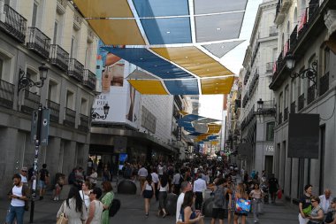 Madrid 'de kalabalık, güneşten korunan Calle de Preciados renkli tuvallerle caddenin karşısına uzandı. 