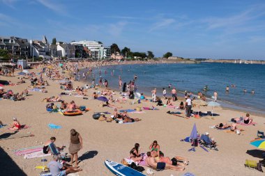 Toulhars sahilindeki turistler Brittany 'deki Larmor-Plage' da