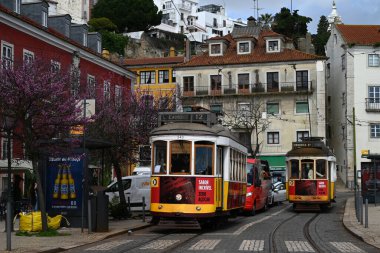Lizbon 'un iki tramvayı 12 numaralı toplu taşıma hattı bir caddeden geçiyor.