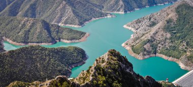 Blue green Kozjak lake surrounded by hills in the mountains of Macedonia. Large artificial lake. Breathtaking panoramic view. clipart