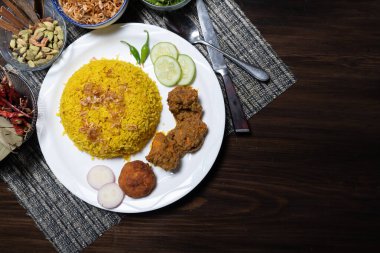 Khichdi or Khichuri with Chicken Bhuna, kebab, and salad served in a dish isolated on the background top view of Bangladesh food clipart