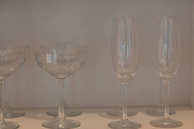 Şarap için farklı bardaklar, şampanya kokteylleri, beyaz bir rafta duranlar. Yüksek kalite fotoğraf