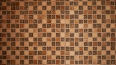 Duvar kare desenli kahverengi fayanslarla döşenmiş iç duvar ya da zemin dekorasyonu için modaya uygun seramik fayanslar..