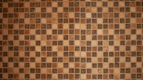 Duvar kare desenli kahverengi fayanslarla döşenmiş iç duvar ya da zemin dekorasyonu için modaya uygun seramik fayanslar..