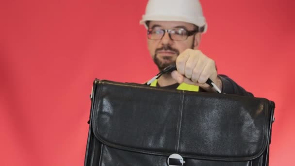 保護ハードハットのプロのエンジニアは頭が動揺感を下げる ひげを生やした男で眼鏡オープン作業スーツケースクローズアップスローモーション — ストック動画