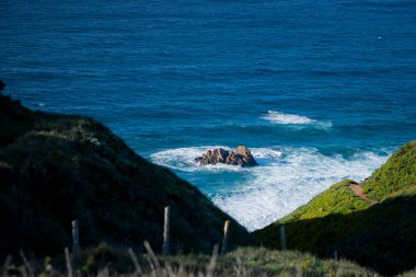 A rocky little island off the coast of the ocean in Portugal. 