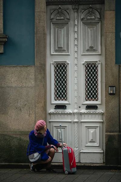 Kvinna Med Resväska Väntar Vid Dörren Till Ett Traditionellt Hus — Stockfoto
