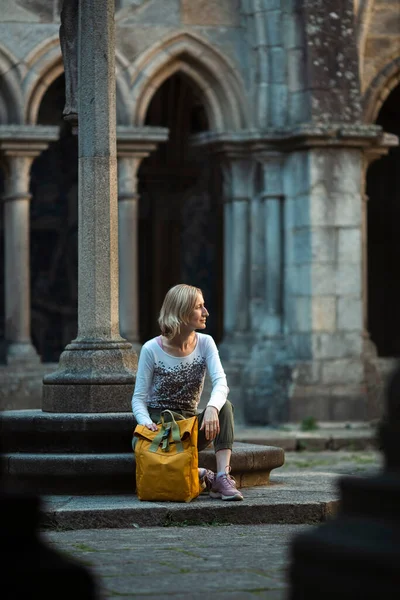 Μια Γυναίκα Ταξιδευτής Κάθεται Στα Σκαλιά Ενός Αρχαίου Φρουρίου — Φωτογραφία Αρχείου