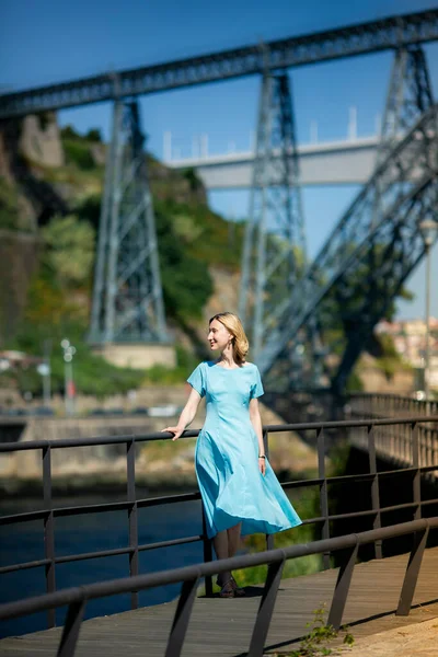 一个穿着蓝色衣服的女人站在人行道上 — 图库照片